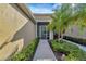 Front entry with walkway, landscaping, and screened door at 27133 Ipswich Dr, Englewood, FL 34223