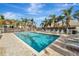 Community pool with lounge chairs and palm trees at 27133 Ipswich Dr, Englewood, FL 34223