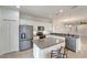 Kitchen with island, stainless steel appliances, and white cabinets at 27133 Ipswich Dr, Englewood, FL 34223