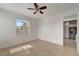 Bedroom with tile floors, ceiling fan, and access to a bathroom at 27133 Ipswich Dr, Englewood, FL 34223