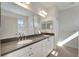 Bright bathroom with double vanity and large mirror at 27133 Ipswich Dr, Englewood, FL 34223