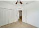 Bedroom with double door closet and ceiling fan at 27133 Ipswich Dr, Englewood, FL 34223