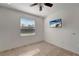 Bedroom with large window and ceiling fan at 27133 Ipswich Dr, Englewood, FL 34223