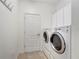Laundry room with washer, dryer and cabinets at 27133 Ipswich Dr, Englewood, FL 34223