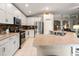 Modern kitchen with stainless steel appliances and ample counter space at 34701 Pinehurst Greene Way, Zephyrhills, FL 33541