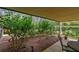 Private patio with lush greenery, stone pavers, and outdoor seating at 36750 Us Highway 19 N # 03127, Palm Harbor, FL 34684