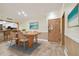 Cozy dining room with wood table, wicker chairs, and a view of the kitchen bar at 36750 Us Highway 19 N # 03127, Palm Harbor, FL 34684