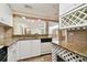 Kitchen boasts granite countertops and white cabinets at 36750 Us Highway 19 N # 03127, Palm Harbor, FL 34684