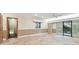 Spacious living room with tile flooring, neutral walls, and sliding glass doors to the outdoors at 36750 Us Highway 19 N # 03127, Palm Harbor, FL 34684