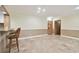 Living area with tile floors, kitchen bar, and access to hallway at 36750 Us Highway 19 N # 03127, Palm Harbor, FL 34684