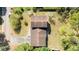 Aerial view showcases the home's roof and surroundings with a long driveway and mature trees at 514 Crestover Dr, Temple Terrace, FL 33617
