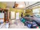 Spacious garage with ample storage, car, and access door to the house at 514 Crestover Dr, Temple Terrace, FL 33617