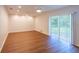 Spacious living room with new hardwood floors and a sliding glass door to the yard at 514 Crestover Dr, Temple Terrace, FL 33617