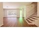 Spacious living room with new flooring, staircase, and ample natural light from large windows at 514 Crestover Dr, Temple Terrace, FL 33617