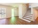 Open-concept living space with stylish new floors, white walls and a view of the staircase at 514 Crestover Dr, Temple Terrace, FL 33617