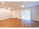 Spacious living room with new hardwood floors and a sliding glass door to the yard at 514 Crestover Dr, Temple Terrace, FL 33617