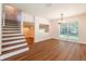 Bright living room with hardwood floors, natural light, and staircase access at 514 Crestover Dr, Temple Terrace, FL 33617