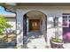 Inviting front entrance featuring double wood doors and an arched entryway, complemented by stylish outdoor lighting at 5181 Horseshoe Ne Pl, St Petersburg, FL 33703