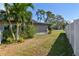 Side yard with lush landscaping and white fence at 5181 Horseshoe Ne Pl, St Petersburg, FL 33703