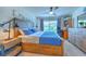 Spacious main bedroom with a large bed, dresser, and built-in desk at 555 Calico Scallop St, Ruskin, FL 33570