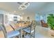 Bright kitchen features white cabinets, granite countertops, and a large dining table at 555 Calico Scallop St, Ruskin, FL 33570
