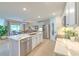 Modern kitchen with white cabinets, stainless steel appliances, and a spacious island at 555 Calico Scallop St, Ruskin, FL 33570