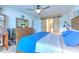 Main bedroom with large bed, barn door to bathroom, and plenty of dresser space at 555 Calico Scallop St, Ruskin, FL 33570
