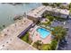 Aerial view of waterfront community with pool, shuffleboard, and parking at 6363 Gulf Winds Dr # 437, St Pete Beach, FL 33706