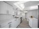 Bright white kitchen features modern appliances and ample cabinetry at 6363 Gulf Winds Dr # 437, St Pete Beach, FL 33706