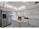 Modern kitchen with white cabinets, stainless steel appliances and an island at 6363 Gulf Winds Dr # 437, St Pete Beach, FL 33706