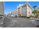 Exterior view of a multi-story condo building with stone accents and well-maintained landscaping at 6363 Gulf Winds Dr # 437, St Pete Beach, FL 33706