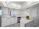 Modern kitchen with white cabinets, stainless steel appliances and an island at 6363 Gulf Winds Dr # 437, St Pete Beach, FL 33706