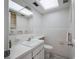 Clean bathroom featuring white tile, a vanity with mirror, and updated flooring at 6363 Gulf Winds Dr # 437, St Pete Beach, FL 33706