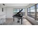 Spacious living area with a grand piano and hardwood floors at 6363 Gulf Winds Dr # 437, St Pete Beach, FL 33706