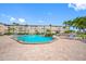 Community pool with surrounding patio and seating at 6363 Gulf Winds Dr # 437, St Pete Beach, FL 33706