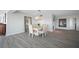 Bright dining room with modern light fixture and hardwood floors at 6363 Gulf Winds Dr # 437, St Pete Beach, FL 33706