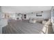 Spacious living room featuring a large sectional sofa and hardwood floors at 6363 Gulf Winds Dr # 437, St Pete Beach, FL 33706