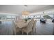Elegant dining room with a modern chandelier and hardwood floors at 6363 Gulf Winds Dr # 437, St Pete Beach, FL 33706