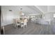 Modern dining area with light hardwood floors and a view into the living room at 6363 Gulf Winds Dr # 437, St Pete Beach, FL 33706