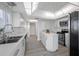 Modern kitchen with white cabinets, stainless steel appliances and an island at 6363 Gulf Winds Dr # 437, St Pete Beach, FL 33706