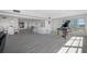 Spacious living area with hardwood floors, a bar, and a grand piano at 6363 Gulf Winds Dr # 437, St Pete Beach, FL 33706