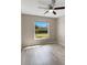 Light-filled bedroom with large window, ceiling fan, and vinyl flooring at 719 Winterbrooke Way, Sun City Center, FL 33573