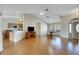 Open living room showcasing hardwood floors and kitchen access at 719 Winterbrooke Way, Sun City Center, FL 33573