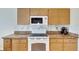 White appliances and granite countertops in this kitchen at 719 Winterbrooke Way, Sun City Center, FL 33573