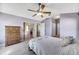 Main bedroom with light walls, wood flooring, and ceiling fan at 719 Winterbrooke Way, Sun City Center, FL 33573