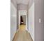 Hallway with light flooring and access to closets and bathroom at 719 Winterbrooke Way, Sun City Center, FL 33573