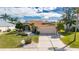 Single-Gathering house with a two-car garage and landscaped yard at 719 Winterbrooke Way, Sun City Center, FL 33573