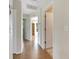 Bright hallway with light wood flooring and multiple doors at 719 Winterbrooke Way, Sun City Center, FL 33573