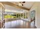 Sunroom with wood flooring, many windows, and access to the outdoors at 719 Winterbrooke Way, Sun City Center, FL 33573
