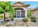 Front entry with screened porch and nicely landscaped area at 719 Winterbrooke Way, Sun City Center, FL 33573